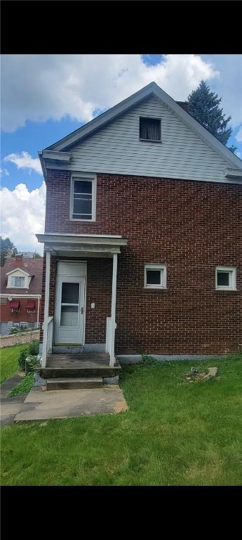 2722 Bethesda St, Carrick, PA 15227 - view of front of home with brick siding and a front lawn
