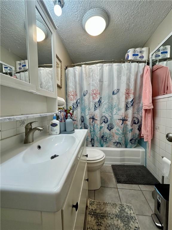 5936 Leprechaun Dr, Bethel Park, PA 15102 - full bathroom with a textured ceiling, vanity, toilet, shower / bath combination with curtain, and tile patterned floors
