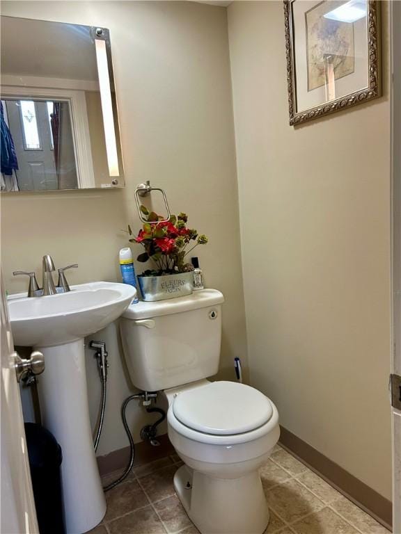 5936 Leprechaun Dr, Bethel Park, PA 15102 - half bath with toilet, a sink, tile patterned flooring, and baseboards