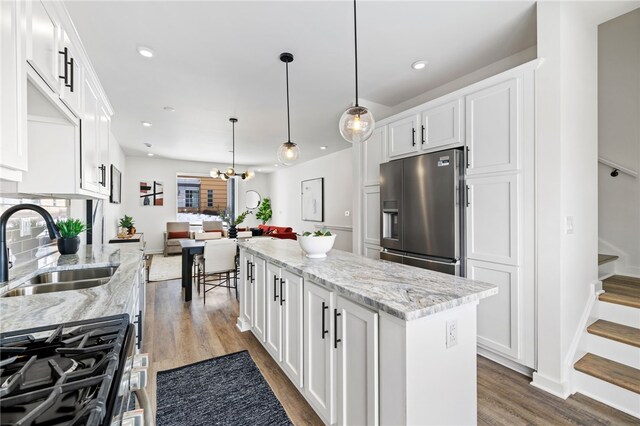 2127 Rose St, Hill District, PA 15219 - kitchen with stainless steel fridge with ice dispenser, a sink, a kitchen island, dark wood finished floors, and white cabinetry