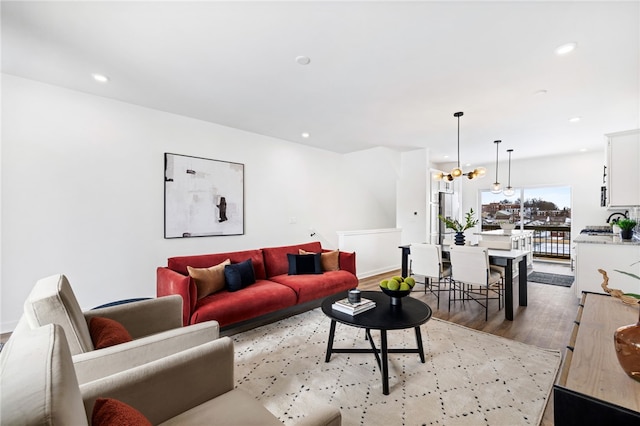2127 Rose St, Hill District, PA 15219 - living room featuring wood finished floors, a chandelier, recessed lighting, and baseboards