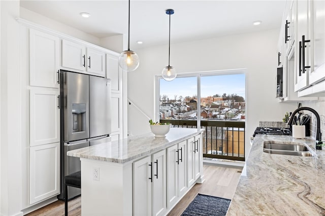 2127 Rose St, Hill District, PA 15219 - kitchen with stainless steel fridge with ice dispenser, light wood-style floors, a sink, white cabinets, and recessed lighting