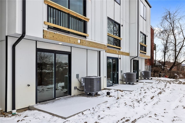 2127 Rose St, Hill District, PA 15219 - snow covered rear of property with central AC, a balcony, and board and batten siding