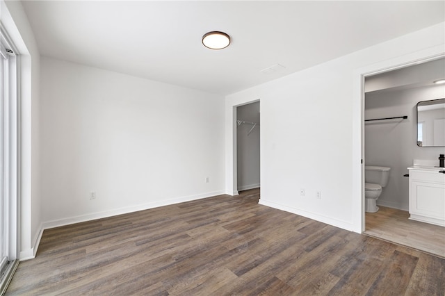 2127 Rose St, Hill District, PA 15219 - unfurnished bedroom with wood finished floors, baseboards, ensuite bathroom, and a walk in closet