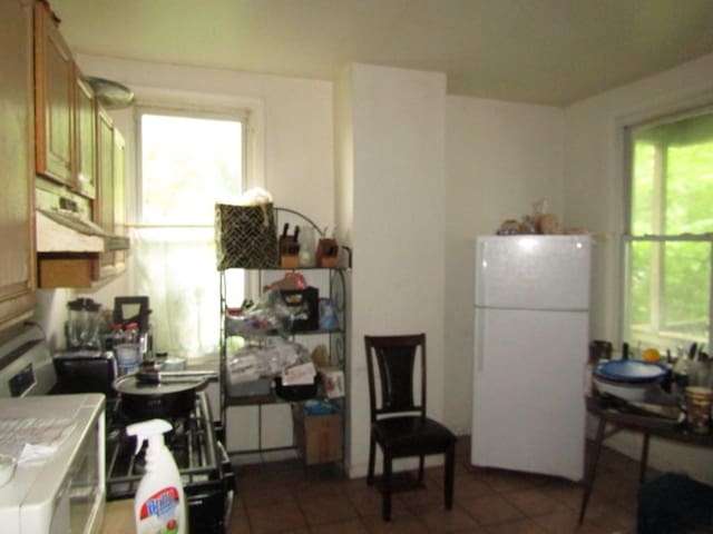 3024 Wadlow St, Brighton Heights, PA 15212 - kitchen with freestanding refrigerator, tile counters, tile patterned flooring, and healthy amount of natural light