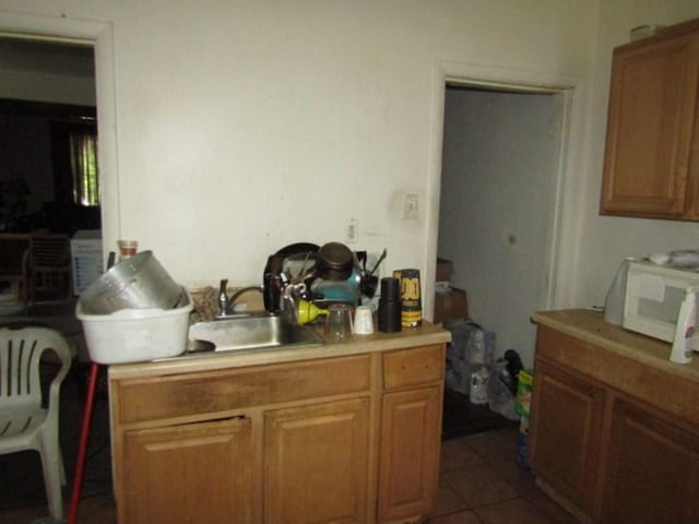 3024 Wadlow St, Brighton Heights, PA 15212 - kitchen featuring white microwave, a sink, light countertops, and dark tile patterned floors