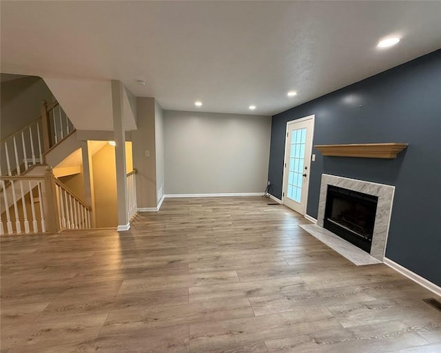 124 Hillvue Dr, Seven Fields Boro, PA 16046 - unfurnished living room featuring a fireplace, wood finished floors, recessed lighting, and stairway
