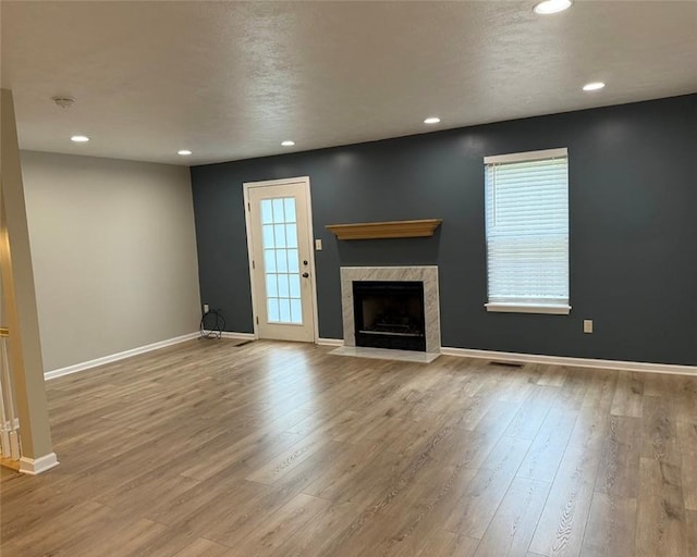 124 Hillvue Dr, Seven Fields Boro, PA 16046 - unfurnished living room featuring recessed lighting, healthy amount of natural light, wood finished floors, and a tiled fireplace