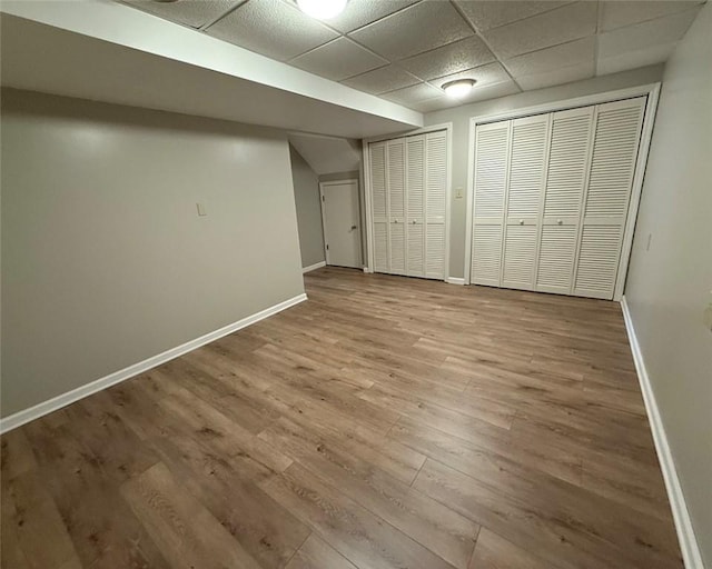 124 Hillvue Dr, Seven Fields Boro, PA 16046 - unfurnished bedroom featuring wood finished floors, multiple closets, and a paneled ceiling