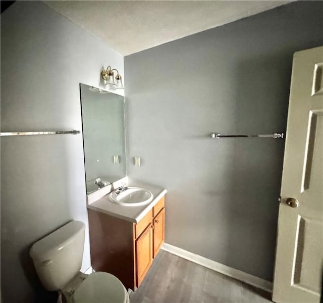 123 Pine Creek Dr, Peters Twp, PA 15367 - half bathroom featuring vanity, wood finished floors, toilet, and baseboards