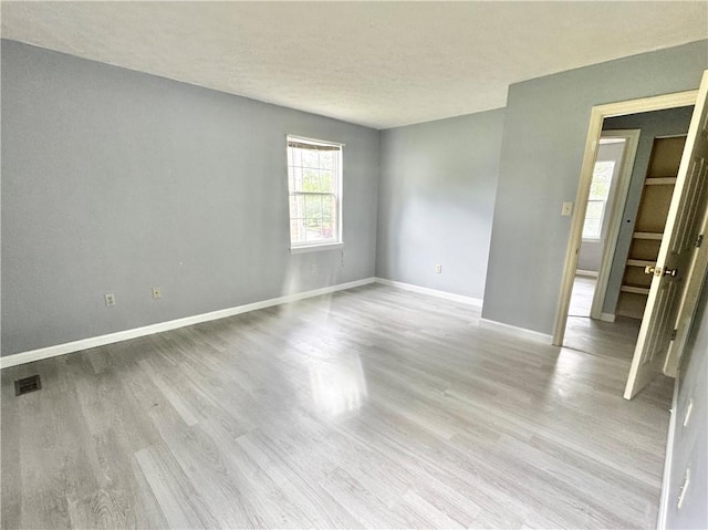 123 Pine Creek Dr, Peters Twp, PA 15367 - spare room featuring light wood-style floors, baseboards, and a textured ceiling