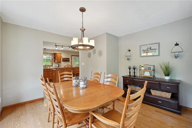 565 Leeper Rd, Green Twp, PA 15043 - dining space featuring light wood-type flooring, a chandelier, track lighting, and baseboards