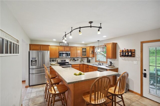 565 Leeper Rd, Green Twp, PA 15043 - kitchen with appliances with stainless steel finishes, a kitchen breakfast bar, baseboards, a sink, and a center island