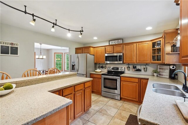 565 Leeper Rd, Green Twp, PA 15043 - kitchen featuring appliances with stainless steel finishes, a sink, brown cabinetry, light tile patterned floors, and glass insert cabinets