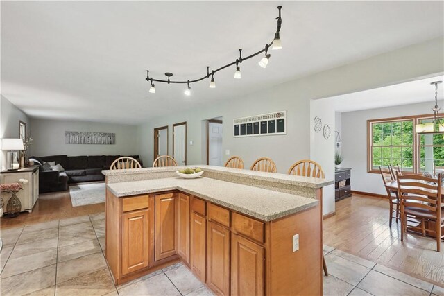 565 Leeper Rd, Green Twp, PA 15043 - kitchen featuring a kitchen breakfast bar, light tile patterned flooring, open floor plan, and a kitchen island