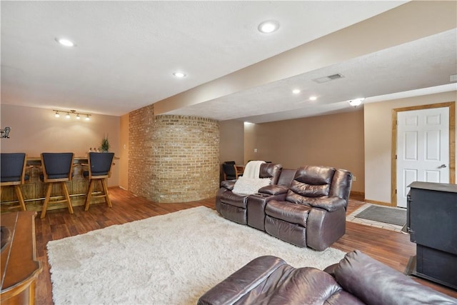 565 Leeper Rd, Green Twp, PA 15043 - living area with wood finished floors, brick wall, a wood stove, and recessed lighting