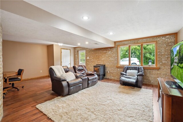 565 Leeper Rd, Green Twp, PA 15043 - living room featuring a wood stove, wood finished floors, brick wall, baseboards, and recessed lighting