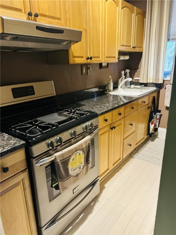 4236 Haldane St, Greenfield, PA 15207 - kitchen featuring stainless steel gas stove, under cabinet range hood, dark stone counters, and light brown cabinets