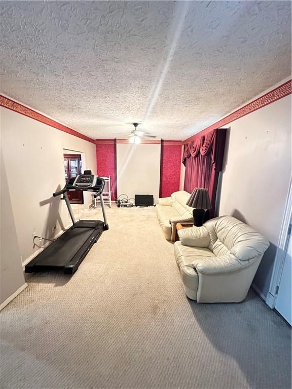 1308 Main St, Aliquippa, PA 15001 - workout room with carpet floors, a ceiling fan, a textured ceiling, crown molding, and baseboards