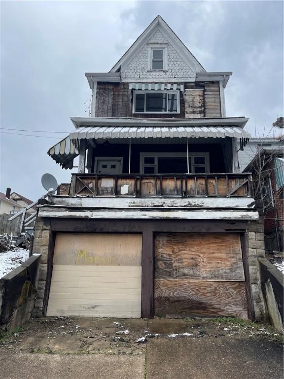 1209 Scott St, Mckeesport, PA 15132 - view of front of property with a balcony, a garage, and stone siding