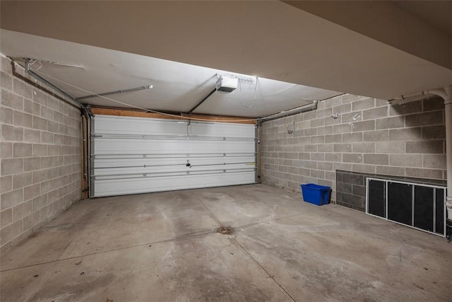 331 Glaser Ave Unit C, Bellevue, PA 15202 - garage featuring a garage door opener and concrete block wall