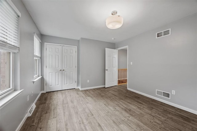 331 Glaser Ave Unit C, Bellevue, PA 15202 - unfurnished bedroom with wood finished floors, multiple windows, and baseboards