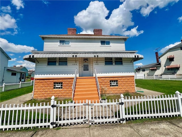 1129 1st St, Redstone Twp, PA 15442 - view of front facade featuring a chimney and a front yard