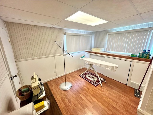 1129 1st St, Redstone Twp, PA 15442 - interior space featuring a drop ceiling, light wood-style flooring, wallpapered walls, and wainscoting