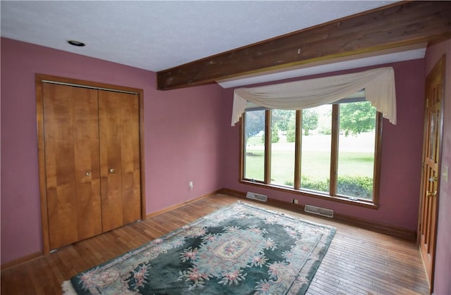 105 Janice Ln, Saxonburg, PA 16056 - unfurnished bedroom with light wood finished floors, a closet, and beamed ceiling