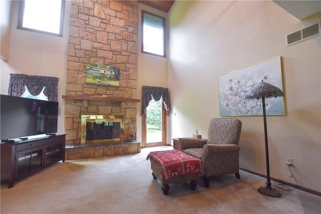 105 Janice Ln, Saxonburg, PA 16056 - living area featuring a towering ceiling, carpet flooring, and a stone fireplace