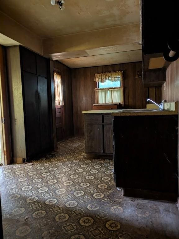 424 N 2nd St, Jeannette, PA 15644 - kitchen featuring wood walls, light countertops, and a sink