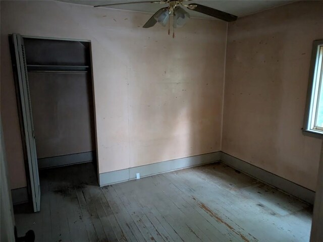 424 N 2nd St, Jeannette, PA 15644 - unfurnished bedroom featuring hardwood / wood-style floors, a closet, baseboards, and a ceiling fan