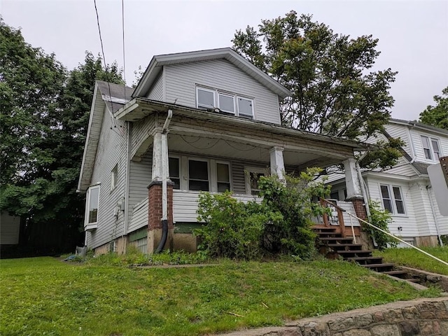 424 N 2nd St, Jeannette, PA 15644 - view of front facade featuring covered porch, a front yard, and stairs