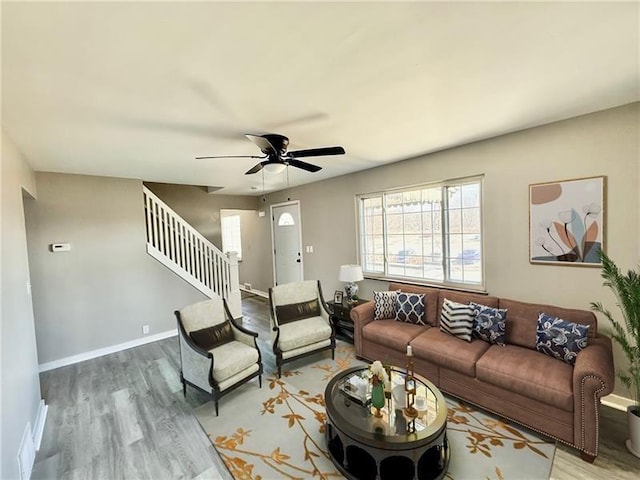 183 Pittsburgh Cir, Ellwood City Law, PA 16117 - living area featuring stairway, wood finished floors, a ceiling fan, and baseboards