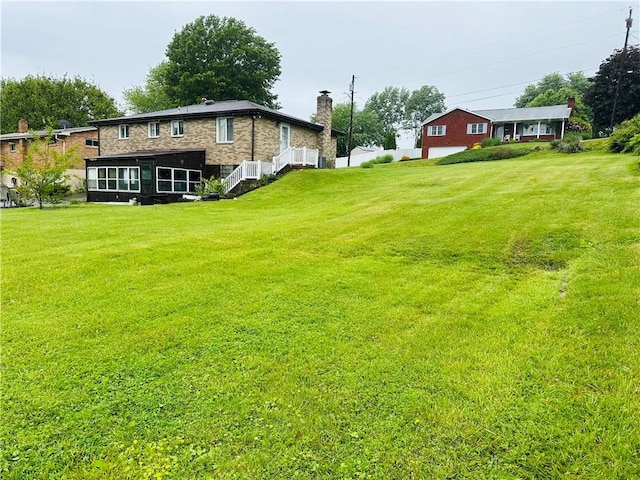 1026 Jefferson Ave, Jeannette, PA 15644 - view of green lawn with a sunroom and stairway