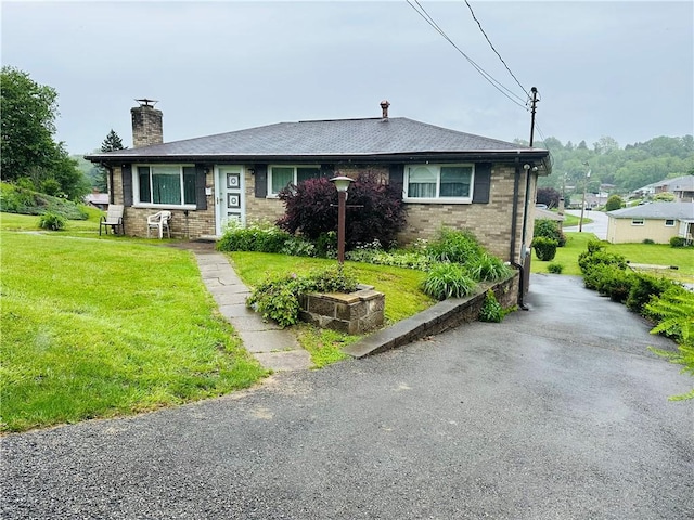1026 Jefferson Ave, Jeannette, PA 15644 - view of front of property with a chimney, a front yard, and brick siding