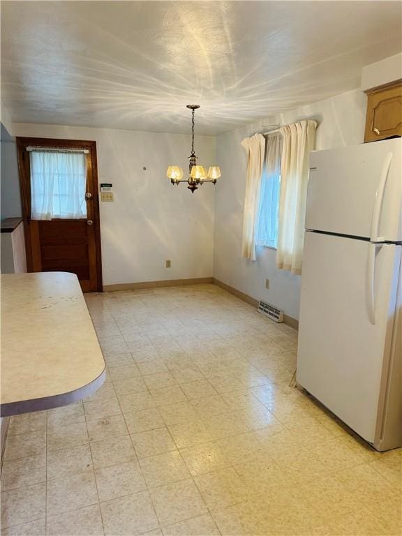 1026 Jefferson Ave, Jeannette, PA 15644 - unfurnished dining area featuring a chandelier and baseboards