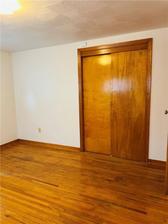 1026 Jefferson Ave, Jeannette, PA 15644 - empty room with wood finished floors and baseboards