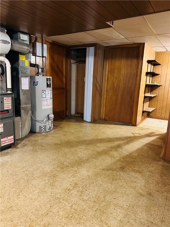 1026 Jefferson Ave, Jeannette, PA 15644 - finished basement with water heater, heating unit, tile patterned floors, and wooden walls
