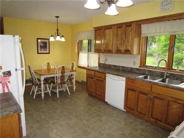 2255 Rombold, Hermitage, PA 16148 - kitchen featuring white appliances, a chandelier, a sink, and brown cabinetry
