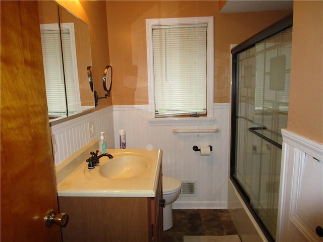 2255 Rombold, Hermitage, PA 16148 - bathroom featuring vanity, toilet, wainscoting, combined bath / shower with glass door, and plenty of natural light