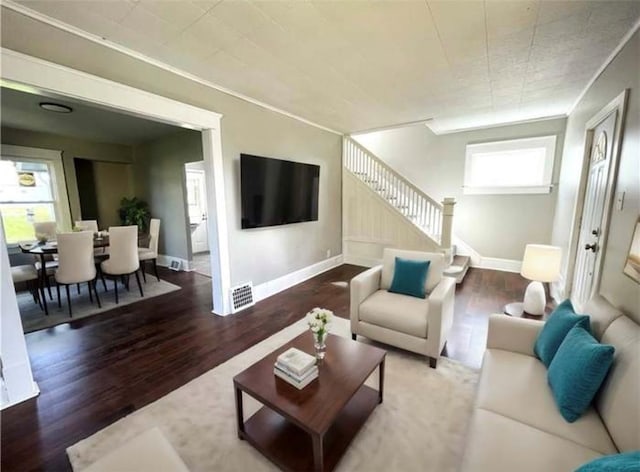 1049 Adams St, New Castle/4Th, PA 16101 - living room with wood finished floors, stairs, and baseboards
