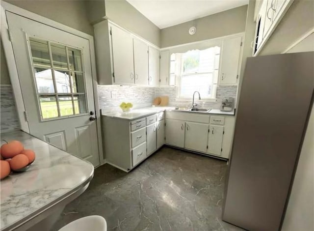 1049 Adams St, New Castle/4Th, PA 16101 - kitchen featuring a sink, freestanding refrigerator, backsplash, and light countertops