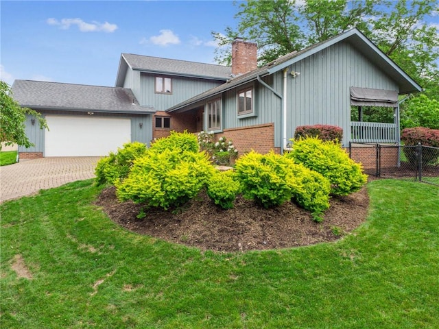 490 Hillside Ave, Monroeville, PA 15146 - view of front of house featuring a chimney, a garage, brick siding, and driveway