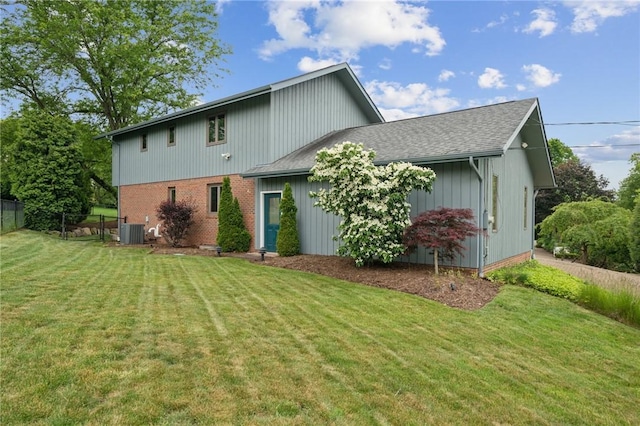 490 Hillside Ave, Monroeville, PA 15146 - back of property featuring a shingled roof, central air condition unit, and brick siding