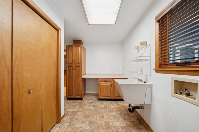 490 Hillside Ave, Monroeville, PA 15146 - laundry area featuring cabinet space, stone finish floors, washer hookup, baseboards, and a desk