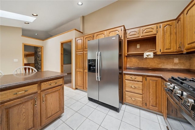 490 Hillside Ave, Monroeville, PA 15146 - kitchen with stainless steel appliances, dark countertops, tasteful backsplash, brown cabinets, and light tile patterned flooring