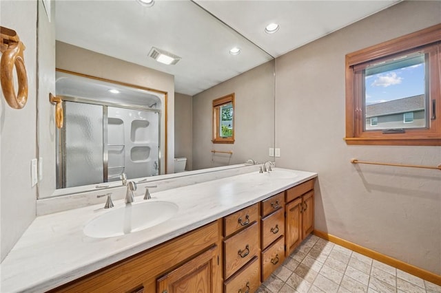 490 Hillside Ave, Monroeville, PA 15146 - full bathroom with toilet, a shower stall, baseboards, double vanity, and recessed lighting