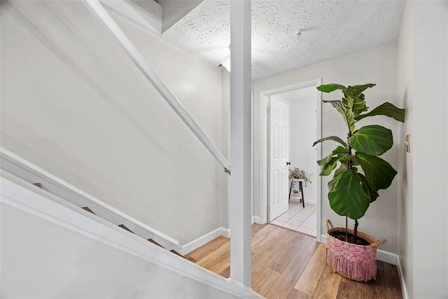113 Stoney Creek Ct, Seven Fields Boro, PA 16046 - stairway featuring wood finished floors, baseboards, and a textured ceiling