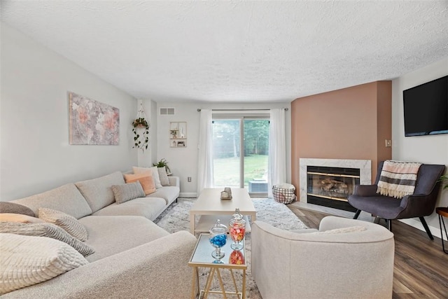 113 Stoney Creek Ct, Seven Fields Boro, PA 16046 - living room featuring a premium fireplace, wood finished floors, and a textured ceiling